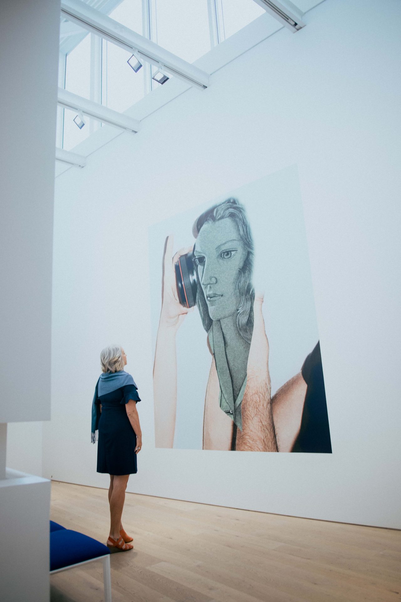 Women looking at large painting