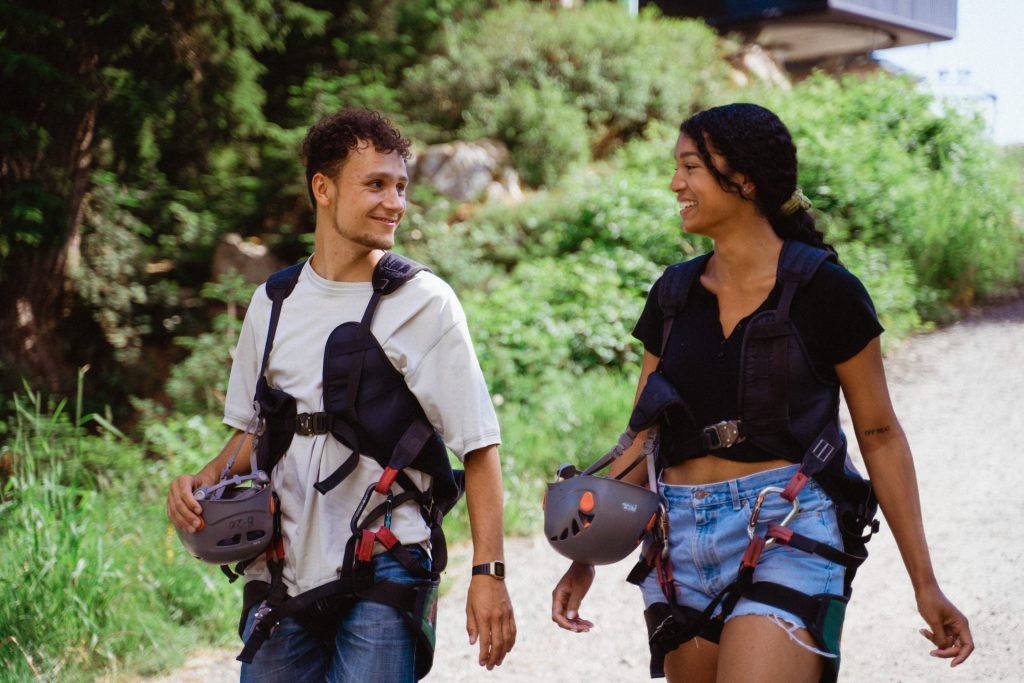 couple in zipline harnesses