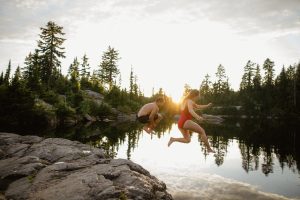 couple jumping in lake